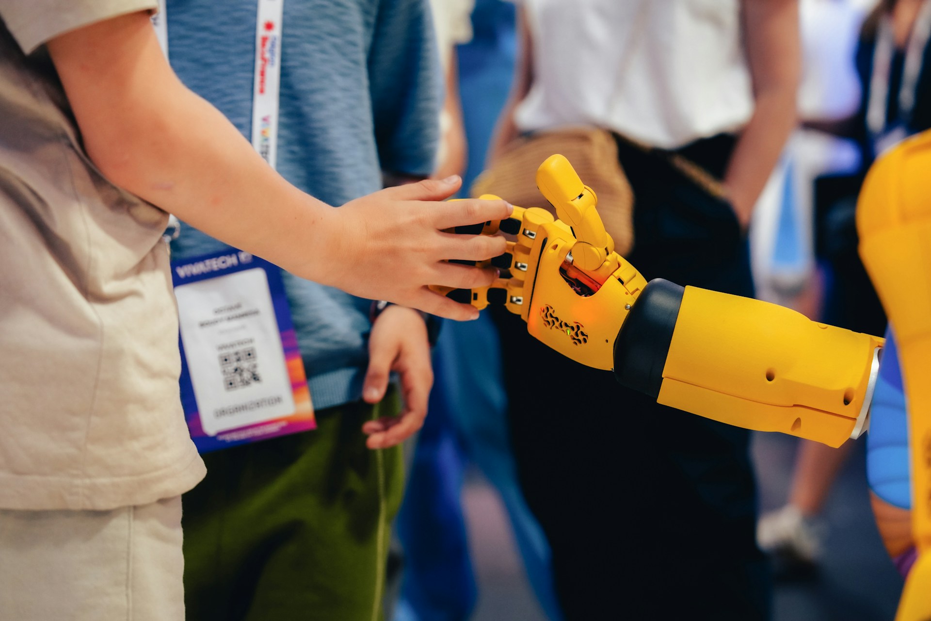 A human hand reaching toward a yellow robotic hand, representing the choice between AI and human translation